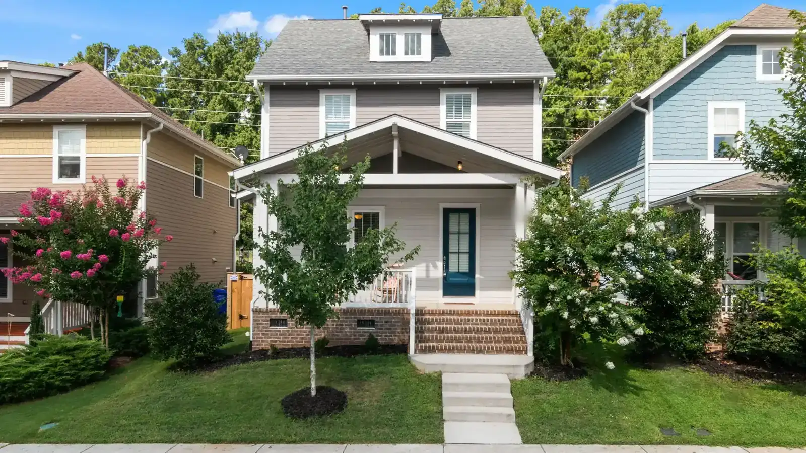 Two-storey house with a covered front porch and a landscaped front yard
